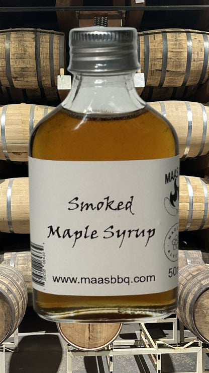 A bottle of Maas BBQ Famous Smoked Maple Syrup made with all-natural ingredients and no additives. A versatile game changer for BBQ meats and a perfect gift for a foodie. Made in Alberta Canada