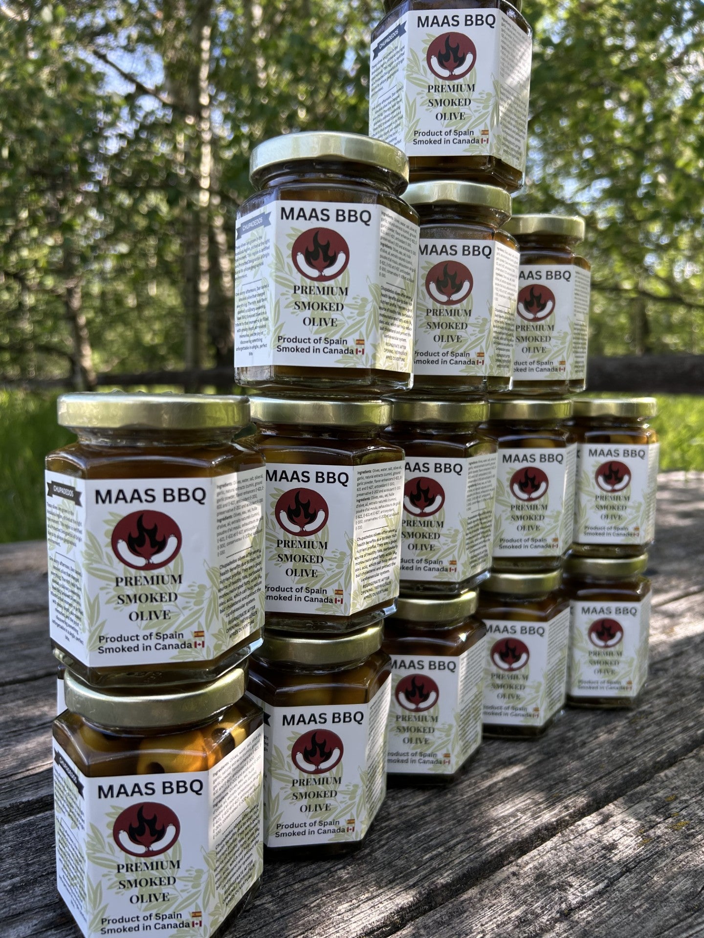 Stack of Maas BBQ Premium Smoked Olive jars, an exclusive gourmet product made in Alberta, Canada, labeled “Canada’s favorite unique smoked spice for BBQ cooking and recipes”, perfect as a great gift for foodies and cooking enthusiasts. Maas BBQ Exclusive Premium Smoked Olives – Canada’s Favorite Gourmet BBQ Ingredient, Unique Smoked Spice Gift for Foodies & Cooking Enthusiasts, Made in Alberta, Canada