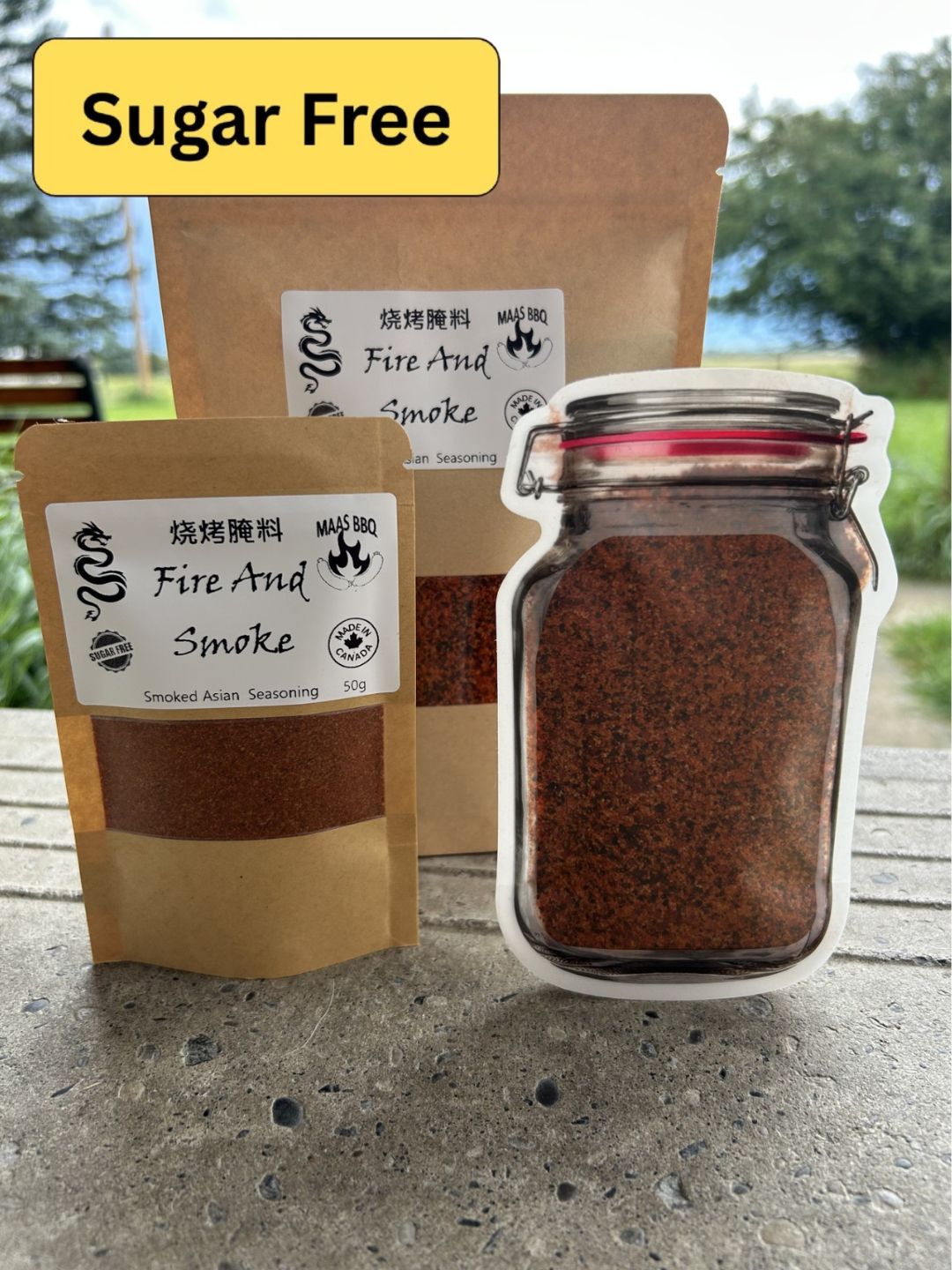 Brown kraft packaging and mason jar pouch and chef size pack of Maas BBQ “Fire And Smoke” sugar‑free famous Asian spice blend, a unique foodie BBQ seasoning labeled  Asian Seasoning 50g, Made in Canada