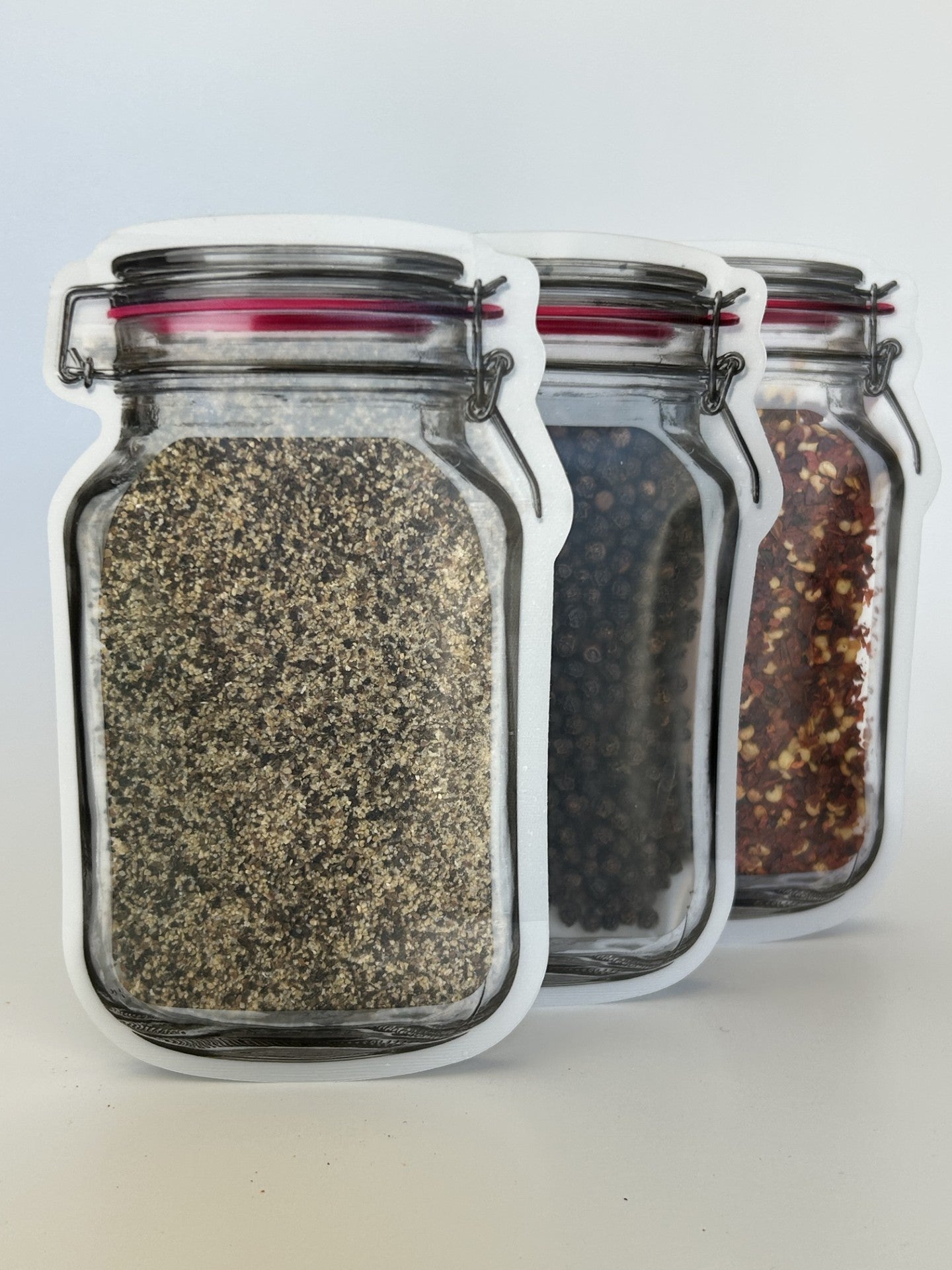 Three re-sealable mason jar bags containing smoked SPG seasoning, black peppercorns, and red pepper flakes – Maas BBQ foodie gift set, unique Alberta Canada made cooking spices for BBQ recipes, Canada’s favorite great gift for cooking enthusiasts.