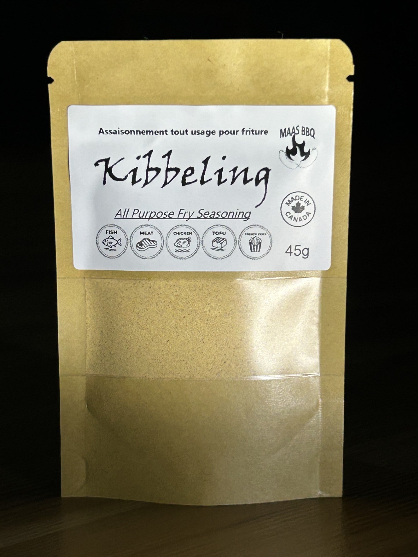 Gold pouch of Maas BBQ Kibbeling all-purpose fry seasoning, a unique famous Dutch spice blend for fish, meat, chicken, tofu and french fries, labeled 'All Purpose Fry Seasoning' with 'Made in Canada' tag, popular foodie fried food seasoning. All-Purpose Fry Seasoning for Fish, Meat & BBQ | Foodie Must-Have