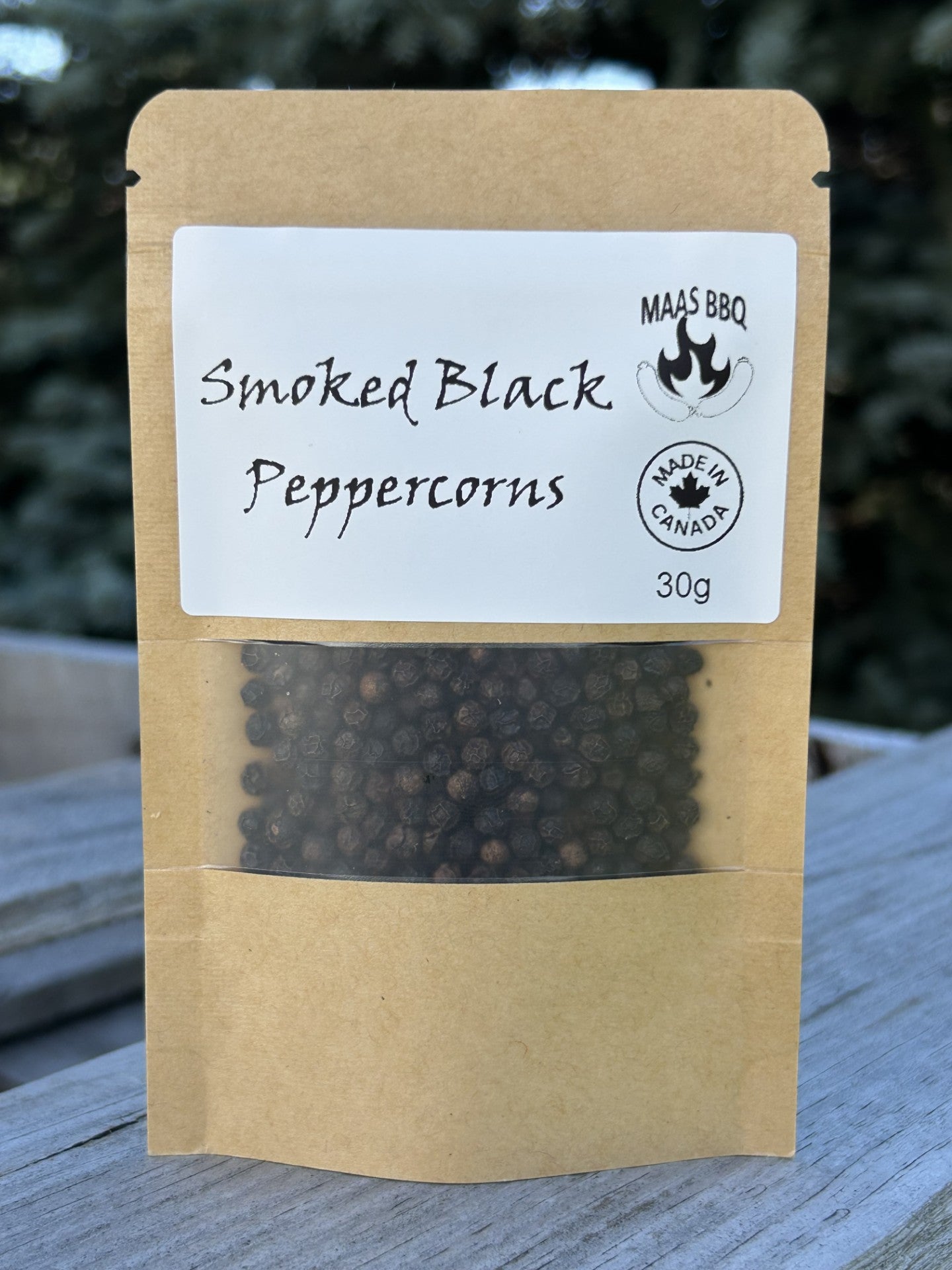 Maas BBQ Smoked Black Peppercorns, a unique 30g travel‑size seasoning pack of smoked black pepper made in Alberta, Canada, shown in a brown kraft pouch with “Smoked Black Peppercorns” label – perfect foodie gift for chefs and cooking lovers.