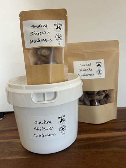 Maas BBQ Smoked Shiitake Mushrooms in various sizes: an 8g kraft pouch, a 70g kraft pouch, and a 220g white bucket, all bearing the "Made in Canada" logo. This high‑end, unique gourmet ingredient, crafted in Alberta, Canada, is perfect for chefs and foodies to infuse dishes with rich, smoky umami flavors, and makes an excellent gift for culinary enthusiasts. Maas BBQ Smoked Shiitake Mushrooms – Unique Gourmet Flavor from Alberta, Canada | High‑End Ingredient for Chefs, Foodies & Unique Gifts
