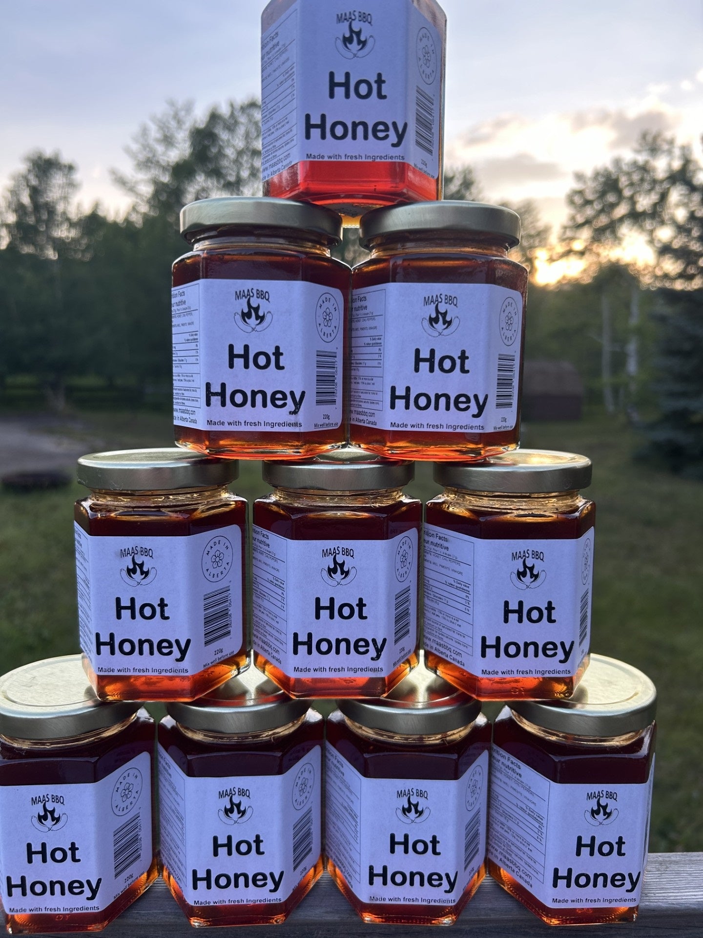 A pyramid of Maas BBQ Hot Honey jars made with fresh, natural ingredients and no additives. A versatile condiment and perfect gift for a foodie.